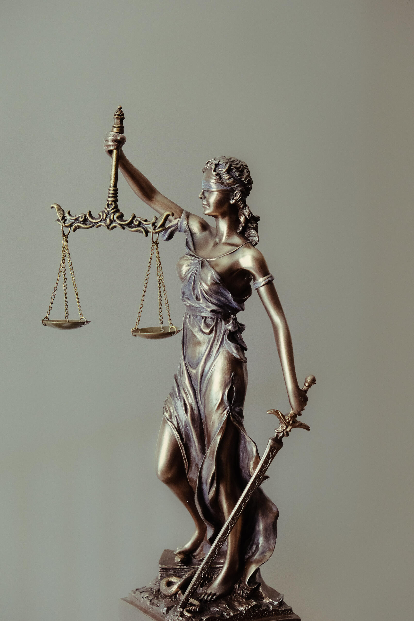 Bronze statue of Lady Justice holding scales